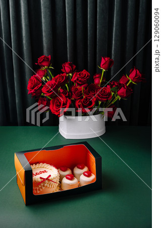 Sweet treats and red roses create a romantic atmosphere for celebrations 129060094