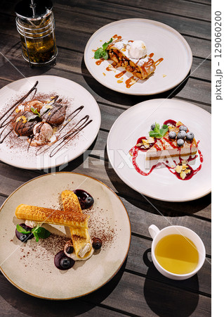 Desserts served at a trendy restaurant with elegant presentation at night Desserts served at a trendy restaurant with elegant presentation at night 129060200