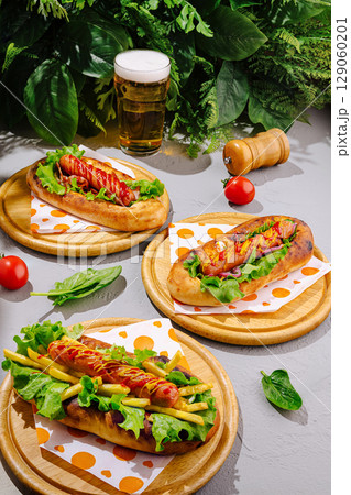 Delicious hot dogs served with fresh ingredients and cold beer in nature 129060201