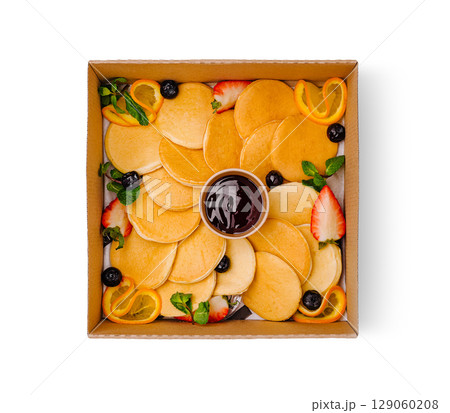 Delicious pancake platter with fresh fruits and syrup for brunch gathering 129060208