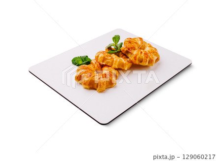 Delicious freshly baked pastries arranged elegantly on a serving board Delicious freshly baked pastries arranged elegantly on a serving board 129060217