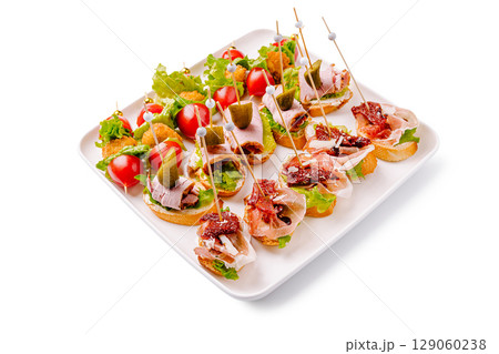 Delicious assortment of appetizers featuring various toppings and garnishes 129060238