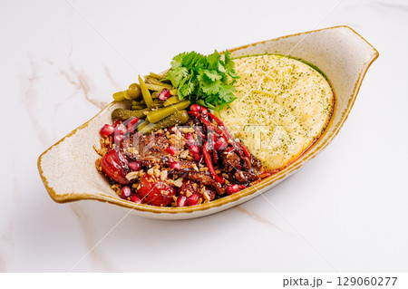 Delicious plate of traditional dish with vibrant ingredients served in a bowl 129060277