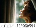 希望の光を見つめるミドル女性の横顔｜穏やかな未来とライフプラン 129060599