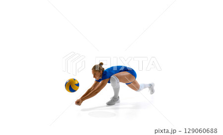 Female volleyball player dives to hit ball on white background Female volleyball player dives to hit ball on white background 129060688