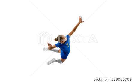 Blue-clad female athlete performing dynamic mid-air jump against white background 129060702