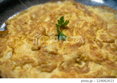 Close-up photo of Omelet served with coriander on the top 129062613
