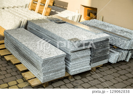Piles of granite marble slabs. Stone sheets for decorative construction. 129062838