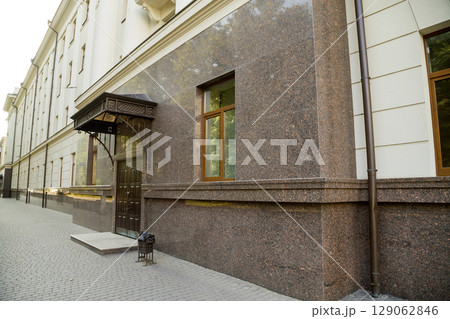 Part of a building facade with the surface of granite wall. Natural stone materials. 129062846