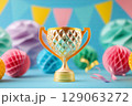 Paper cut golden trophy with party streamers on blue festive background 129063272