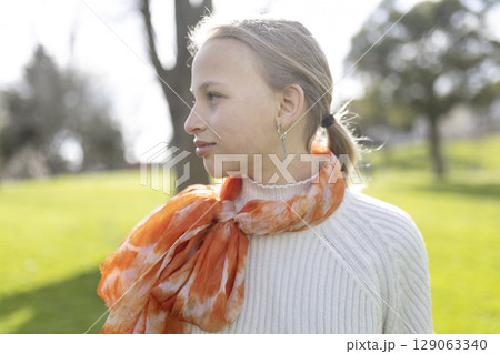 Young girl enjoying a sunny day outdoors Young girl enjoying a sunny day outdoors 129063340