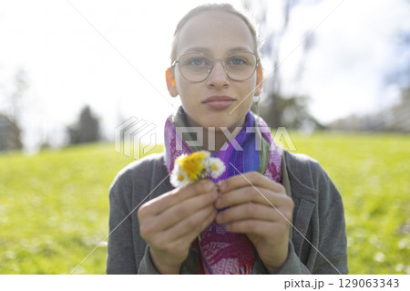 Young person enjoying nature with flowers 129063343