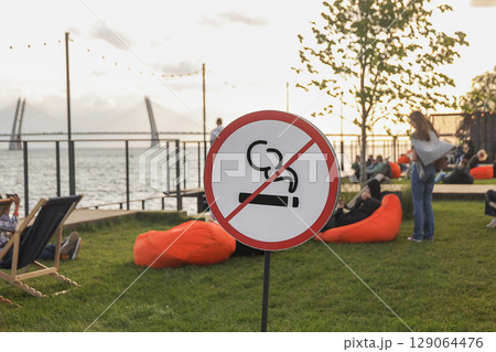 No smoking sign in park on seashore 129064476