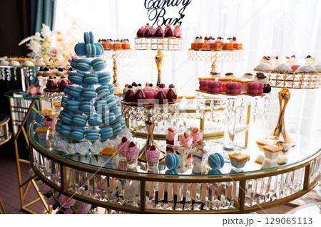 Candy bar showing macarons, cupcakes, and pastries during a celebration 129065113