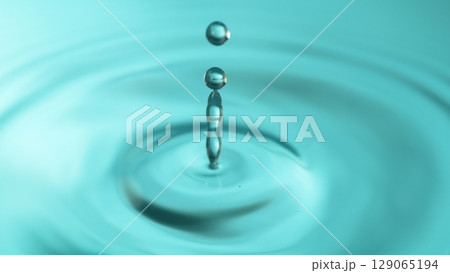Blue Water drop falling, macro splash. Natural background. Blue Water drop falling, macro splash. Natural background. 129065194