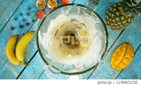 Mixing pieces of fruits in blender, top view. 129065230