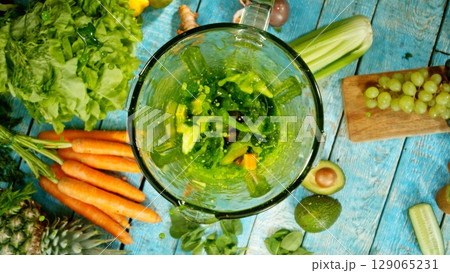 Mixing pieces of fruits and vegetable in blender, top view. 129065231