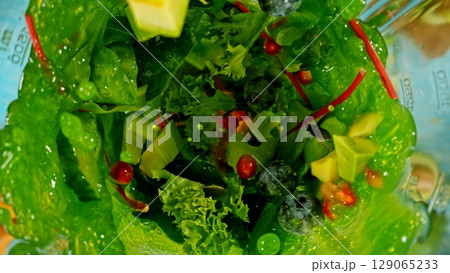 Mixing pieces of fruits and vegetable in blender, top view. 129065233