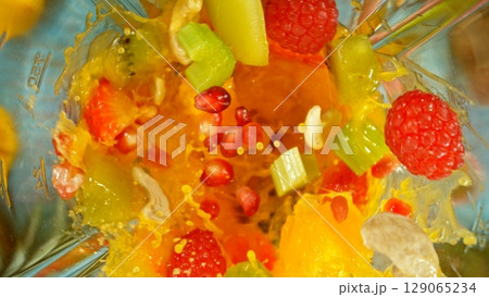 Mixing pieces of fruits in blender, top view. 129065234