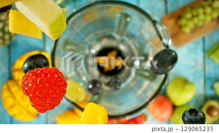 Mixing pieces of fruits in blender, top view. 129065235