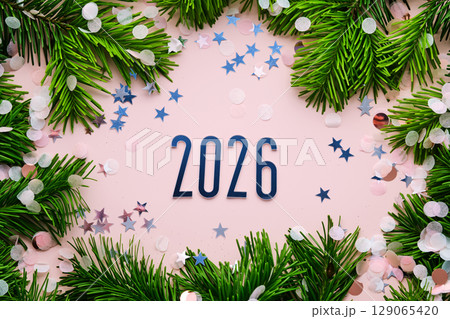 New Year 2026 pink background. Number of the coming year in Christmas decoration. 129065420