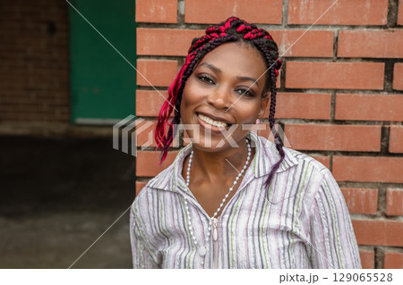 Professional African Business Woman Portrait on Brick Wall 129065528