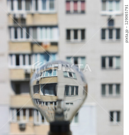 Defocused Light Lamp And Multi Storey Apartment House As An Illustration Of Energy Price And Efficient  129065791