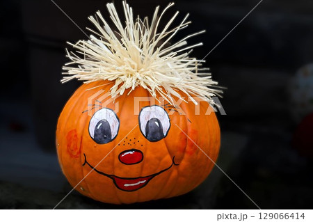Cheerful Hand-Painted Pumpkin with Straw Hair Cheerful Hand-Painted Pumpkin with Straw Hair 129066414