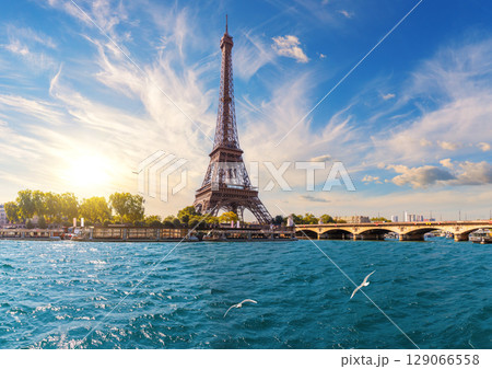 Eiffel Tower and the bridge over Seine river, famous view of Paris, France Eiffel Tower and the bridge over Seine river, famous view of Paris, France 129066558