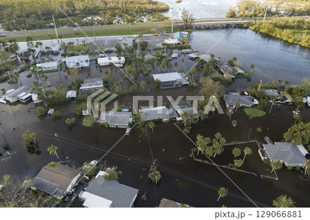 Heavy flood with high water surrounding residential houses after hurricane rainfall in Florida residential area. Consequences of natural disaster 129066881