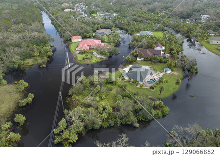 Heavy flood with high water surrounding residential houses after hurricane rainfall in Florida residential area. Consequences of natural disaster 129066882