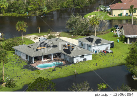 Heavy flood with high water surrounding residential houses after hurricane Ian rainfall in Florida residential area. Consequences of natural disaster Heavy flood with high water surrounding residential houses after hurricane Ian rainfall in Florida residential area. Consequences of natural disaster 129066884
