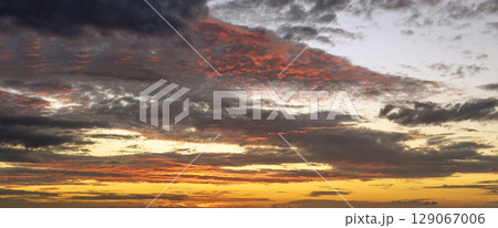 Evening sunset sky with colorful clouds. Panoramic skyscape Evening sunset sky with colorful clouds. Panoramic skyscape 129067006