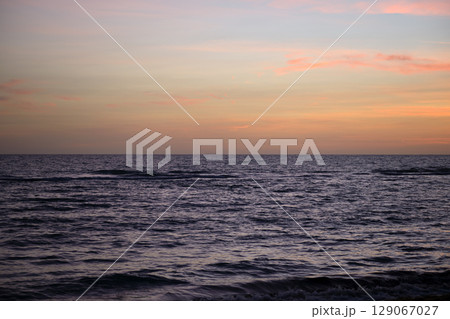 Dramatic red ocean waves at sunset with soft evening sea dark water 129067027