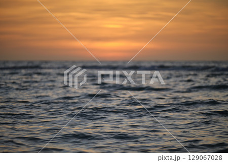 Dramatic red ocean waves at sunset with soft evening sea dark water 129067028