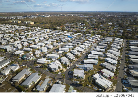 Destroyed by hurricane Ian suburban houses in Florida mobile home residential area. Consequences of natural disaster 129067043