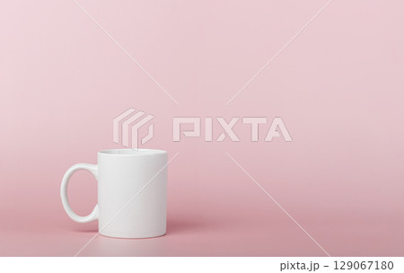 white cup for tea or coffee on a pink background white cup for tea or coffee on a pink background 129067180