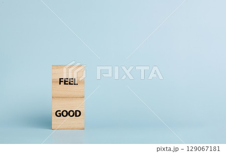 Wooden cubes with inscriptions Feel Good on a blue background Wooden cubes with inscriptions Feel Good on a blue background 129067181
