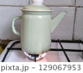 Close up of metal kettle on gas stove in kitchen. 129067953