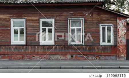 Old Wooden House with White Framed Windows Old Wooden House with White Framed Windows 129068116