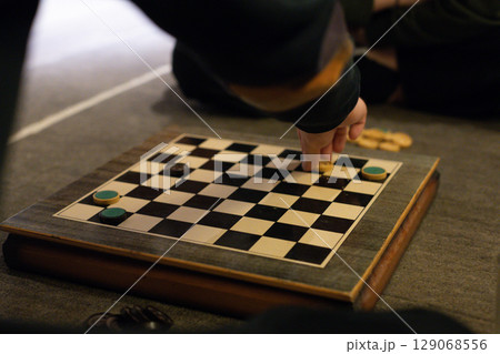 Hand Making Move in Checkers Game Hand Making Move in Checkers Game 129068556