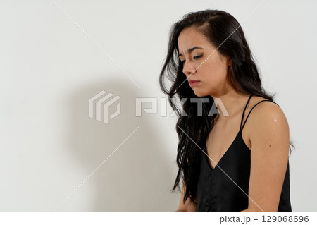 Young latin woman feeling sad and showing negative emotions Young latin woman feeling sad and showing negative emotions 129068696
