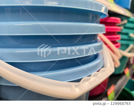 Colorful plastic buckets arranged on a store shelf for creative storage ideas Colorful plastic buckets arranged on a store shelf for creative storage ideas 129068763