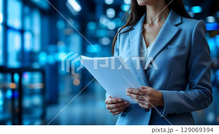 Business, people and technology concept - close up of businesswoman with papers in office 129069394