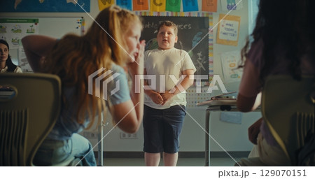 Primary School Boy Showcasing Knowledge of Ecology in Front of Class and Teacher Primary School Boy Showcasing Knowledge of Ecology in Front of Class and Teacher 129070151