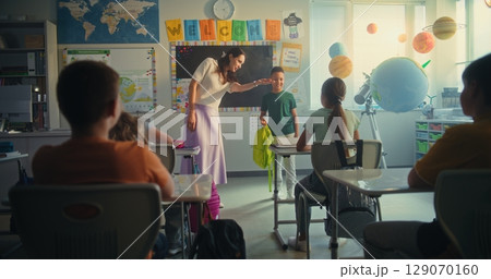 Female Teacher Introducing New Young Student in Front of Class Full of Elementary School Children Female Teacher Introducing New Young Student in Front of Class Full of Elementary School Children 129070160
