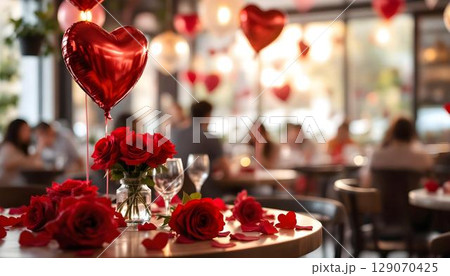 A romantic Valentine's Day table adorned with flowers and balloons, perfect for an intimate dinner setting A romantic Valentine's Day table adorned with flowers and balloons, perfect for an intimate dinner setting 129070425