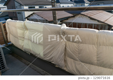 家のベランダの手すりに布団を干す 家のベランダの手すりに布団を干す 129071616