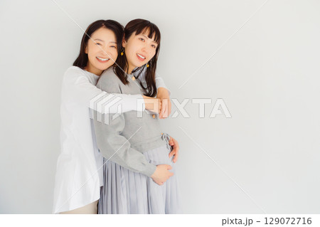 しあわせ一杯の母と臨月間近の娘 129072716