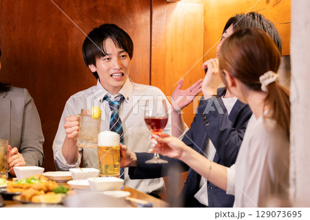 飲み会　居酒屋でお酒を飲んでいる男女 129073695